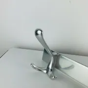 Wall-mounted coat rack, strip of 3 aluminium hooks from the 1960s.