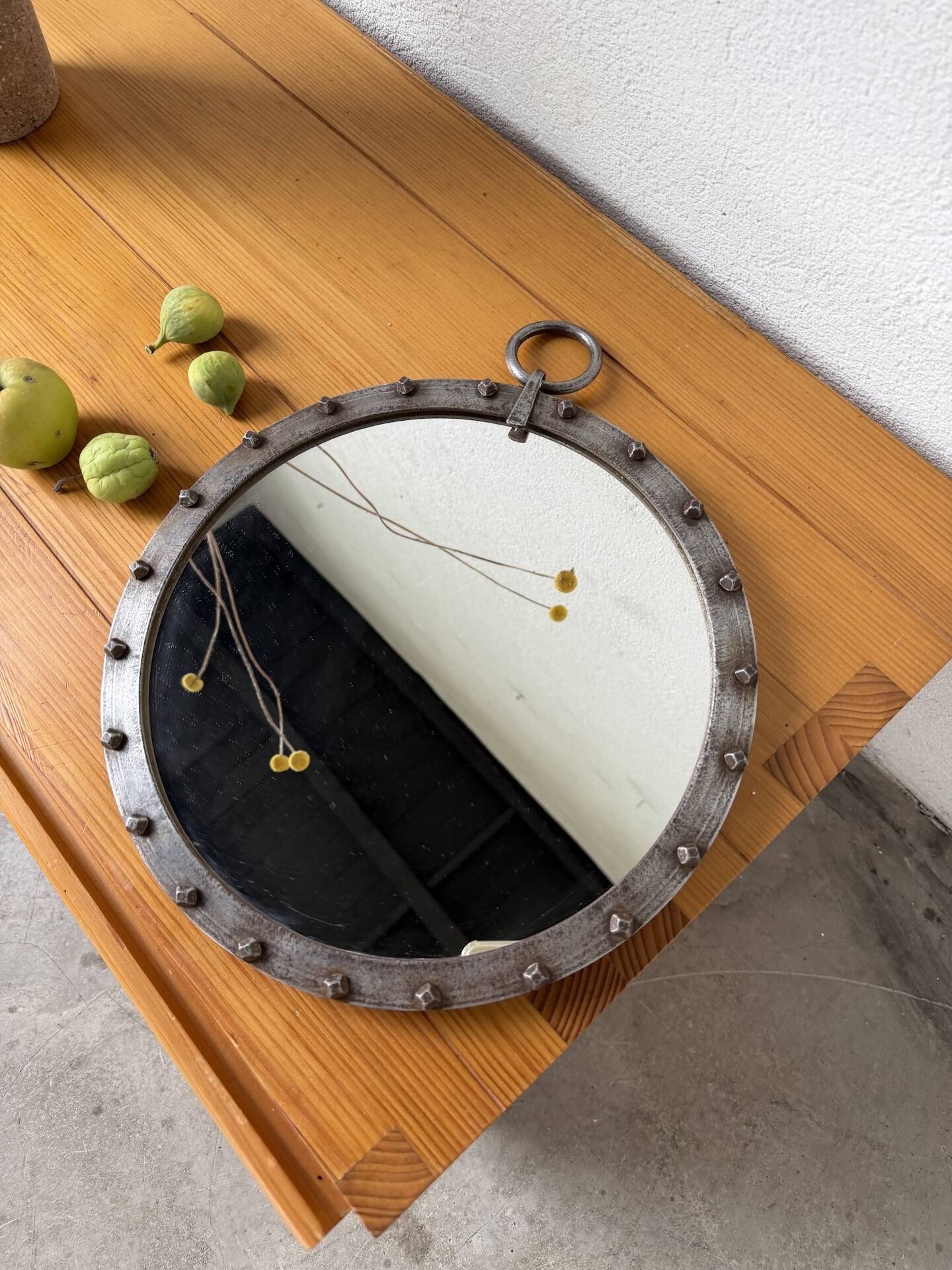 Brutalist round mirror with wrought iron and studs.