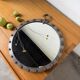 Brutalist round mirror with wrought iron and studs.