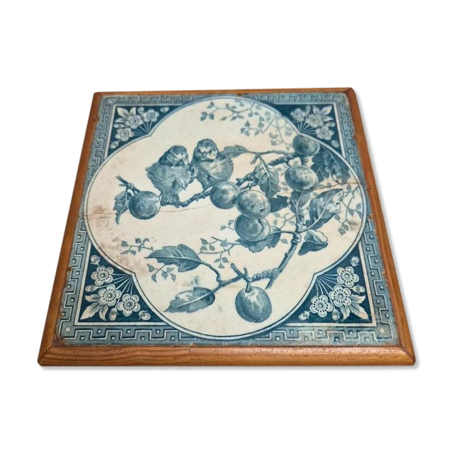 Antique trivet in Gien tile with blue bird decoration – wooden border