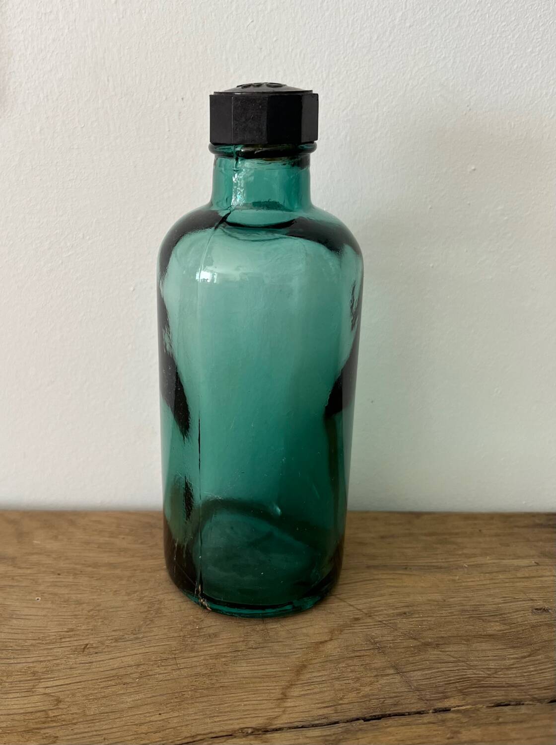 Small vintage dark turquoise blue bottle
