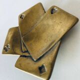 Empty pocket square of aces in brass