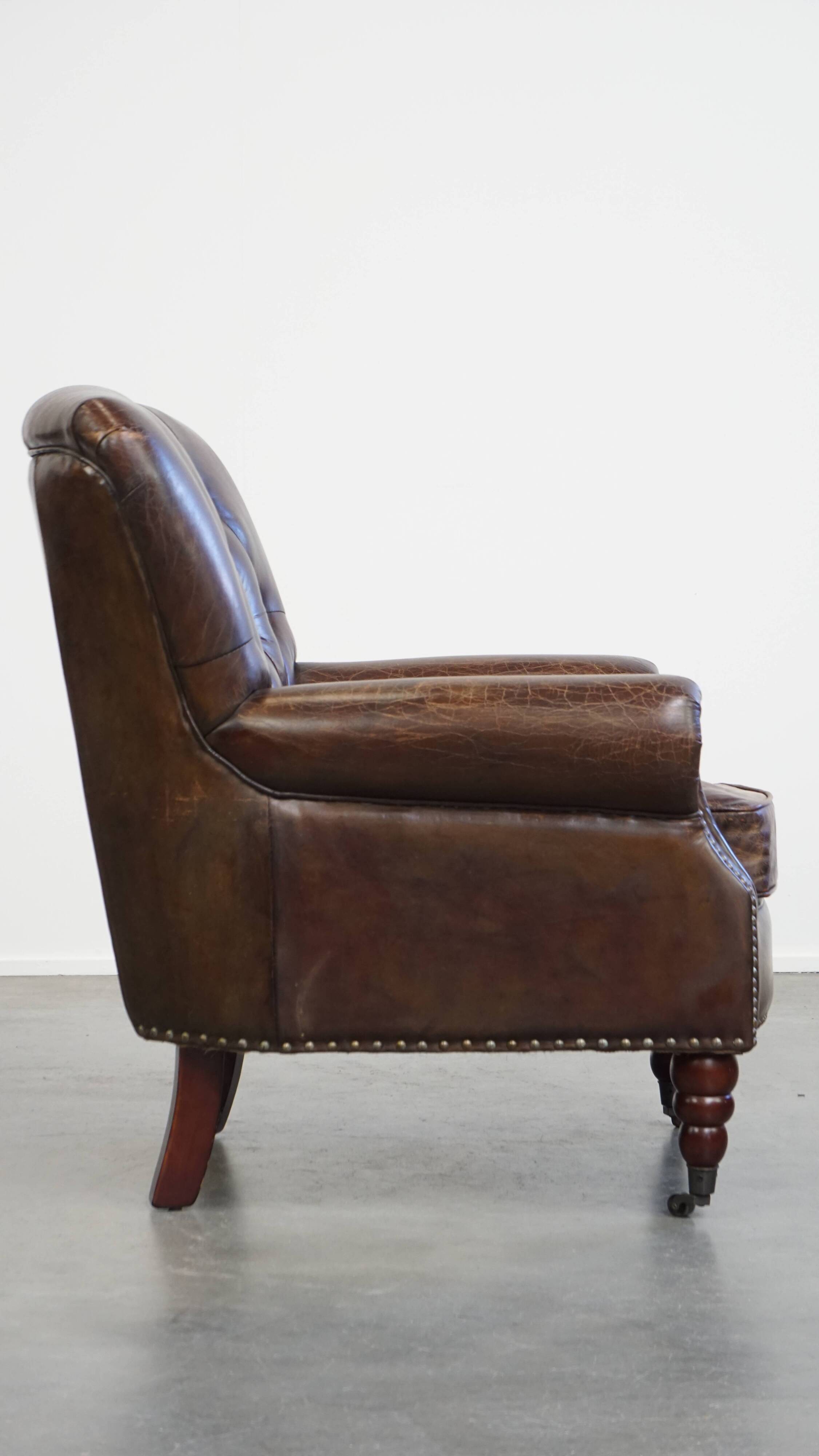 Cognac colored brown grained cowhide chesterfield armchair