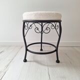 Black iron stool/pouf with its boucle fabric cushion.