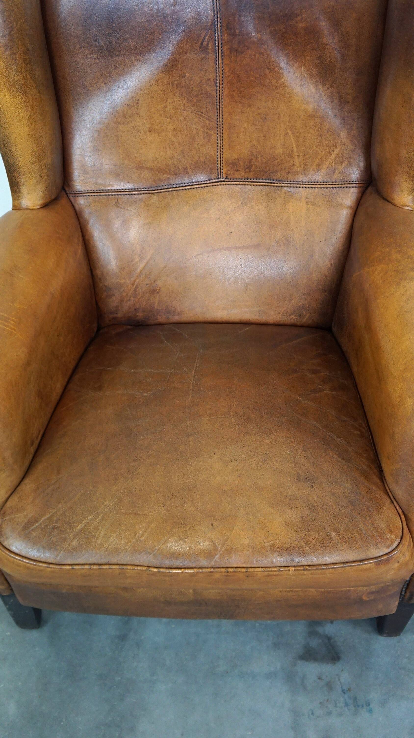 Set of 2 beautiful and correct sheep leather wingback armchairs with fixed seat cushions