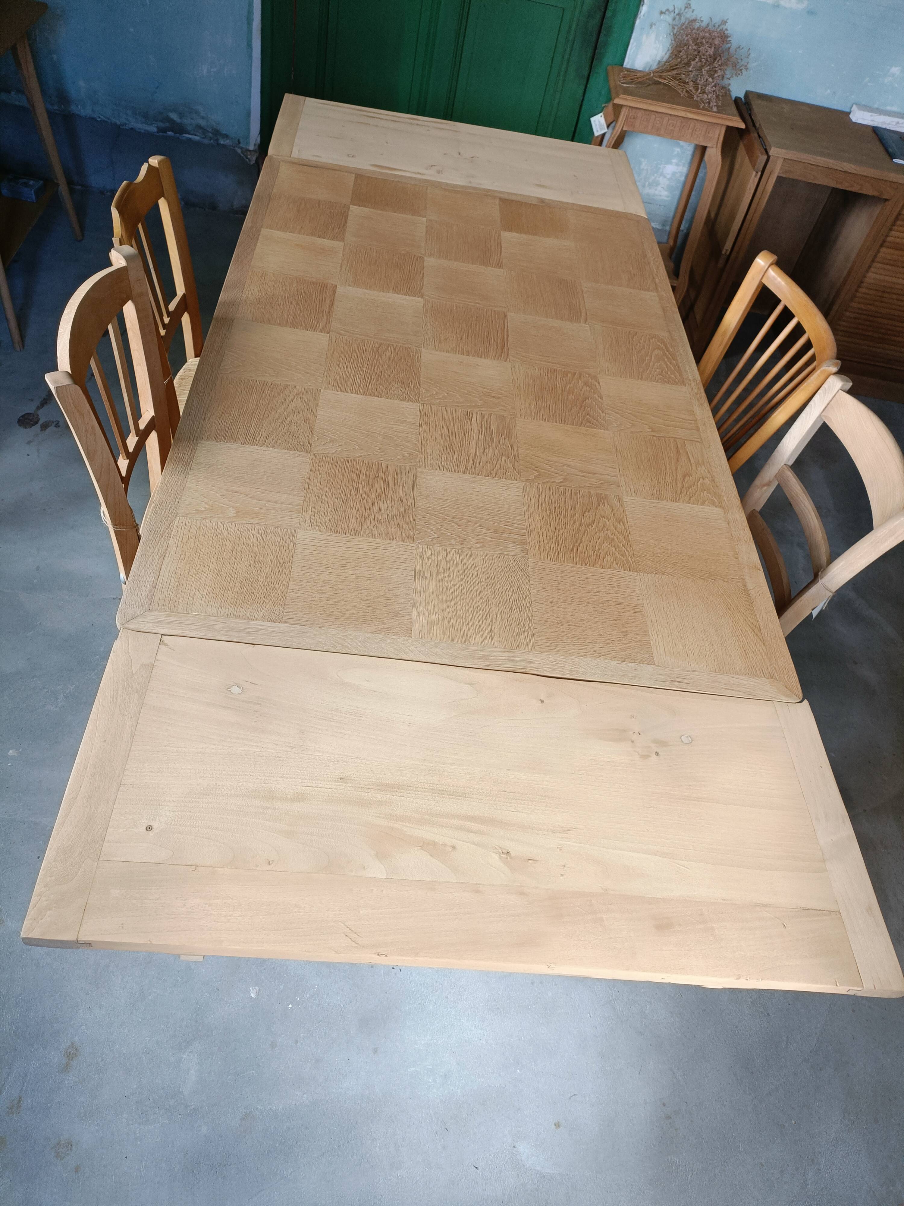 Oak dining table with a checkerboard top and extensions.