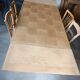 Oak dining table with a checkerboard top and extensions.