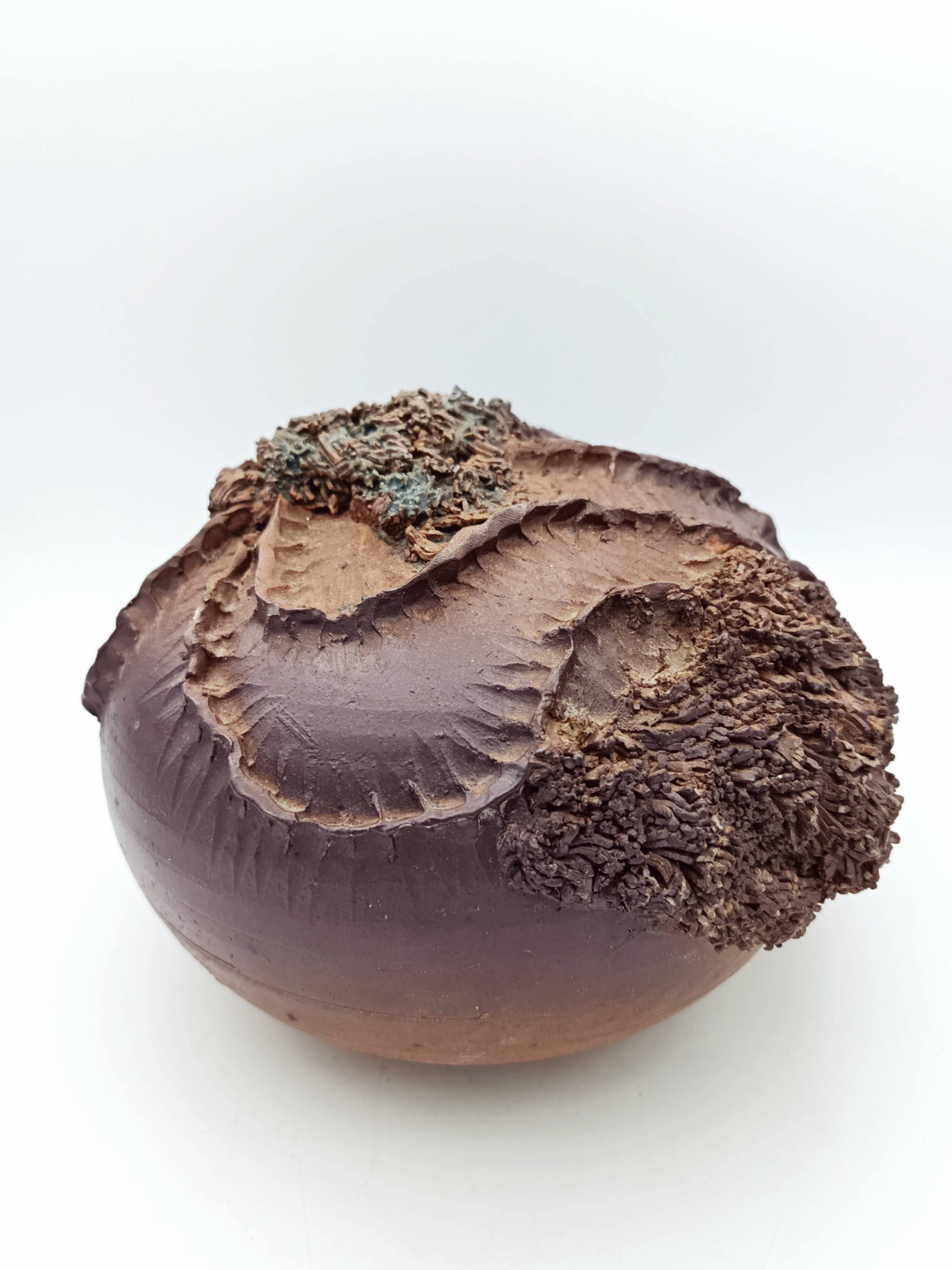 Ceramic vase with organic plant decoration