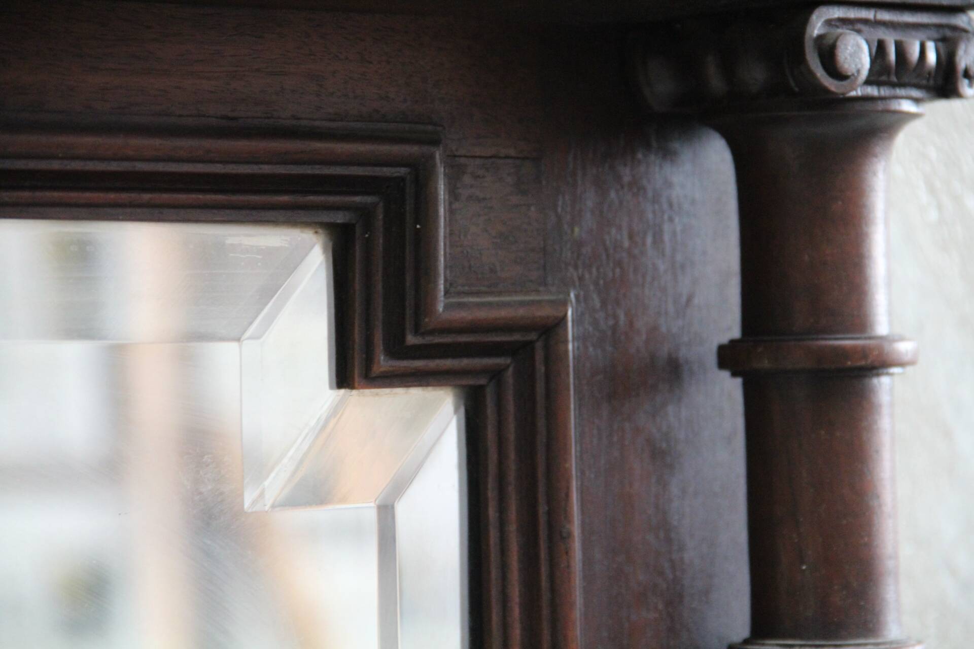 Imposing beveled mirror with wooden frame