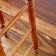 Antique wooden bar stool with a straw seat