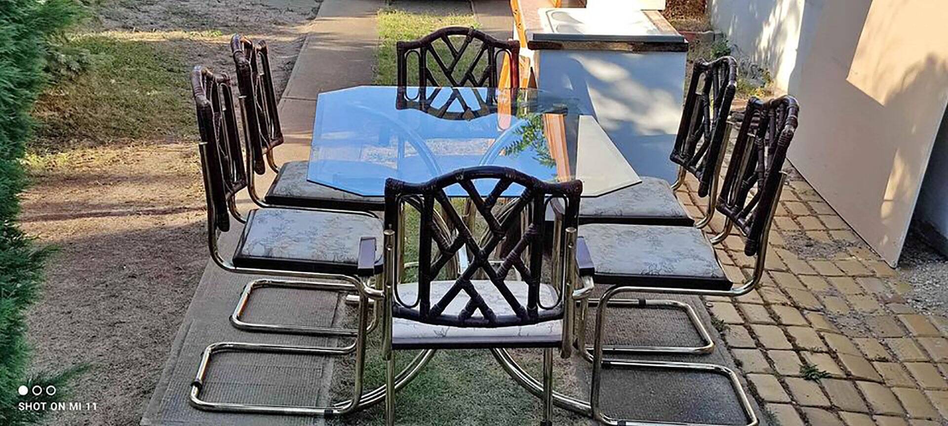Vintage 1970s set in gilded brass, glass table and 6 brown and straw yellow chairs.