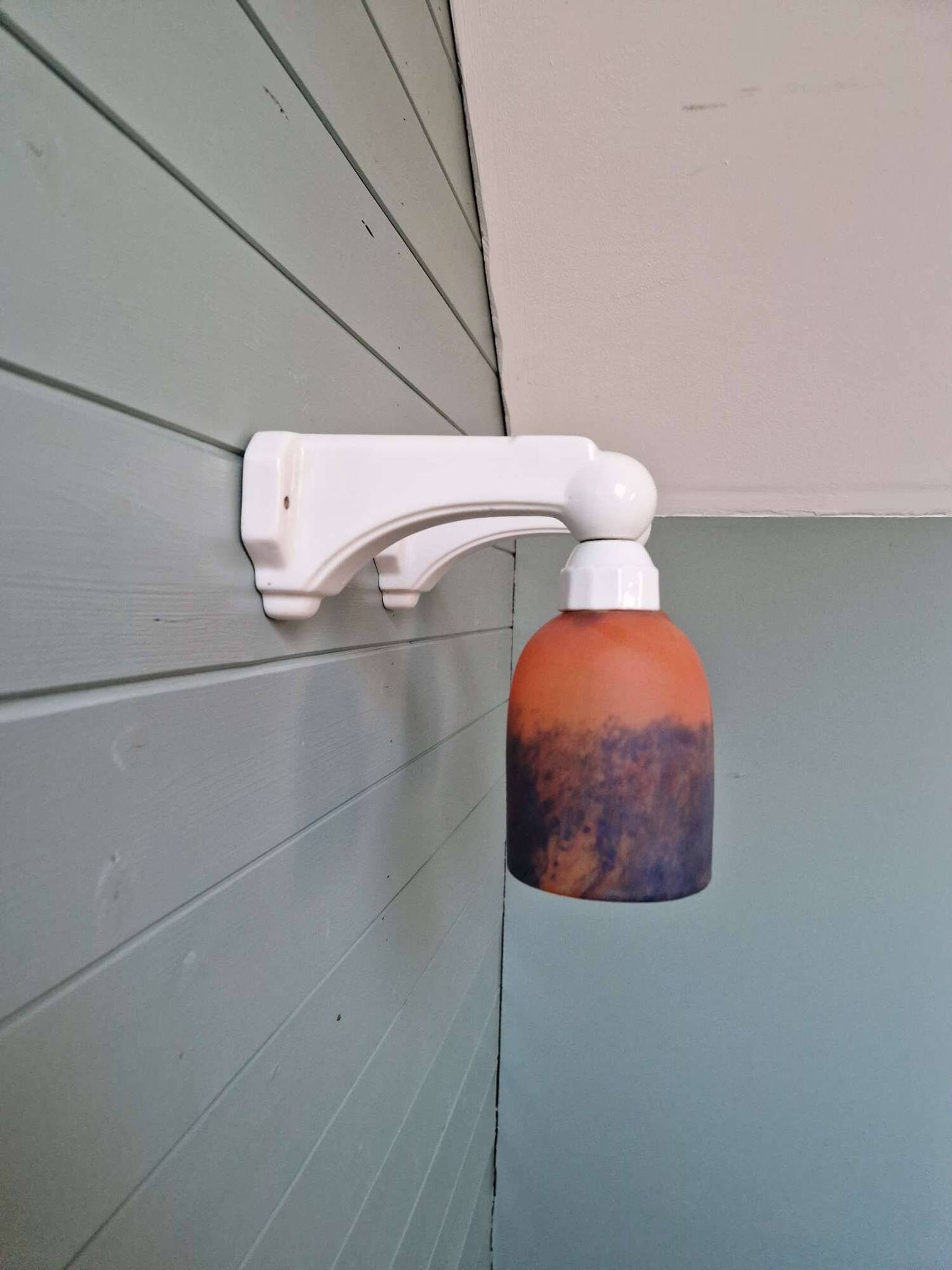 Pair of Art Deco wall sconces in multicoloured porcelain and frosted glass.