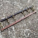Coat rack, teak and brass coat hooks.