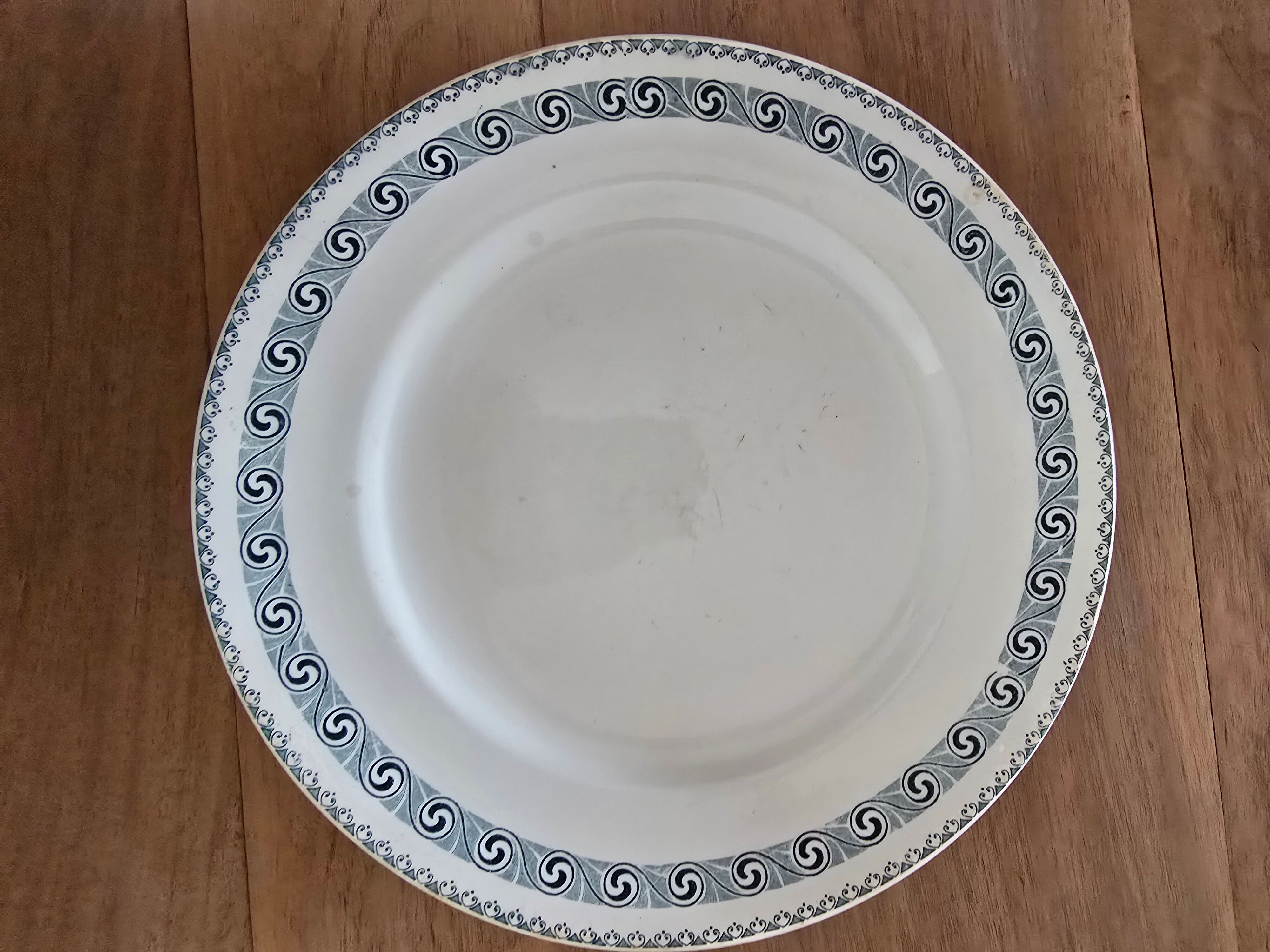 Old green-blue faience plates and dishes with geometric patterns.