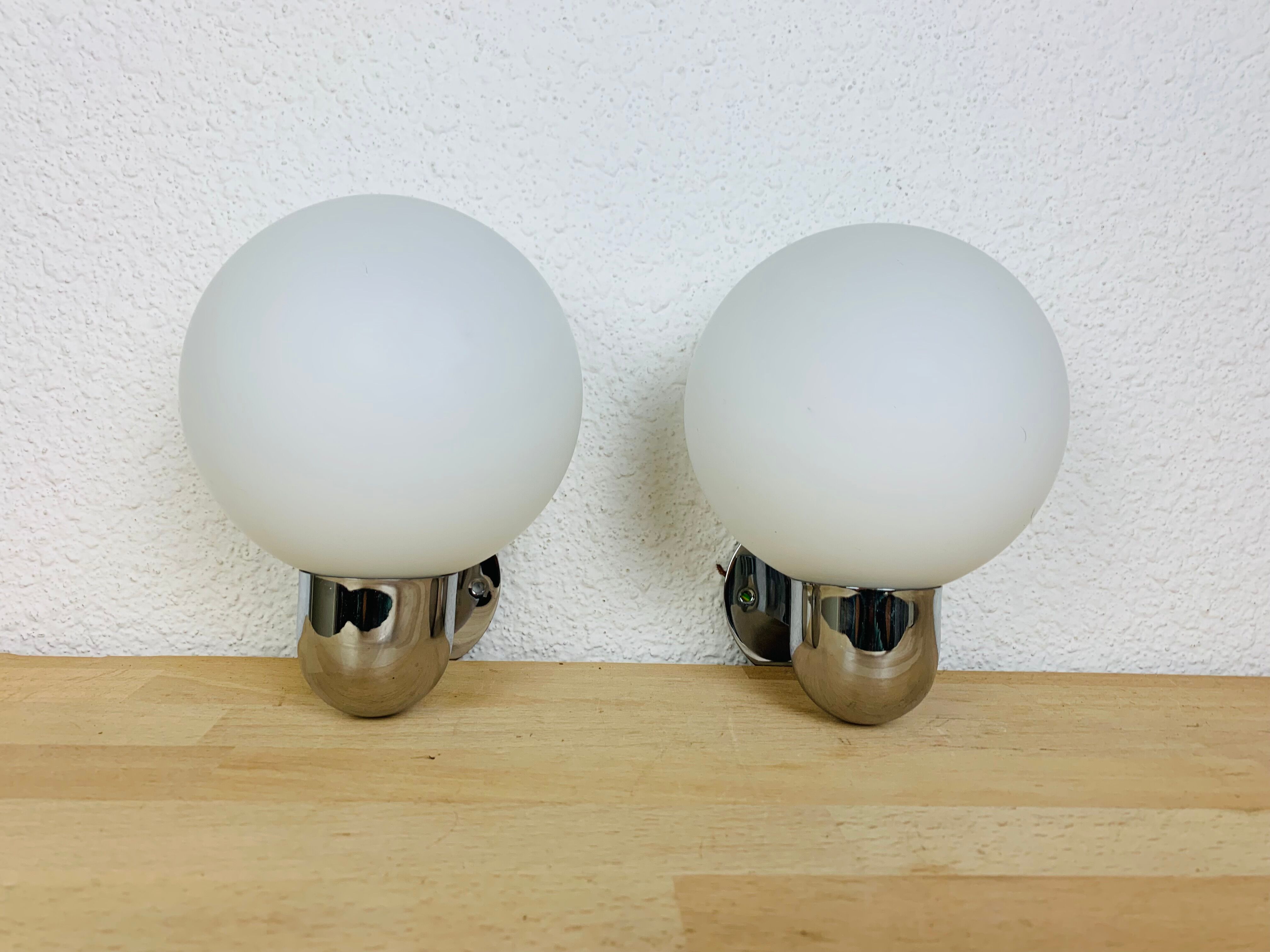 Pair of wall lamps space age chrome and opal globe 70s
