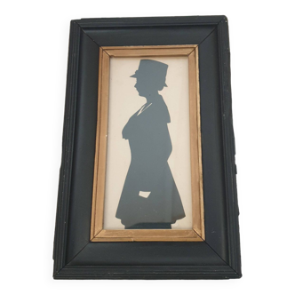 SILHOUETTE PAINTING OF A WOMAN IN A BLACK FRAME