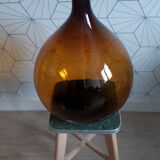 Great old demijohn in amber glass
