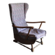 Vintage brown wooden rocking chair from the 1950s, wingback backrest and rocking base.