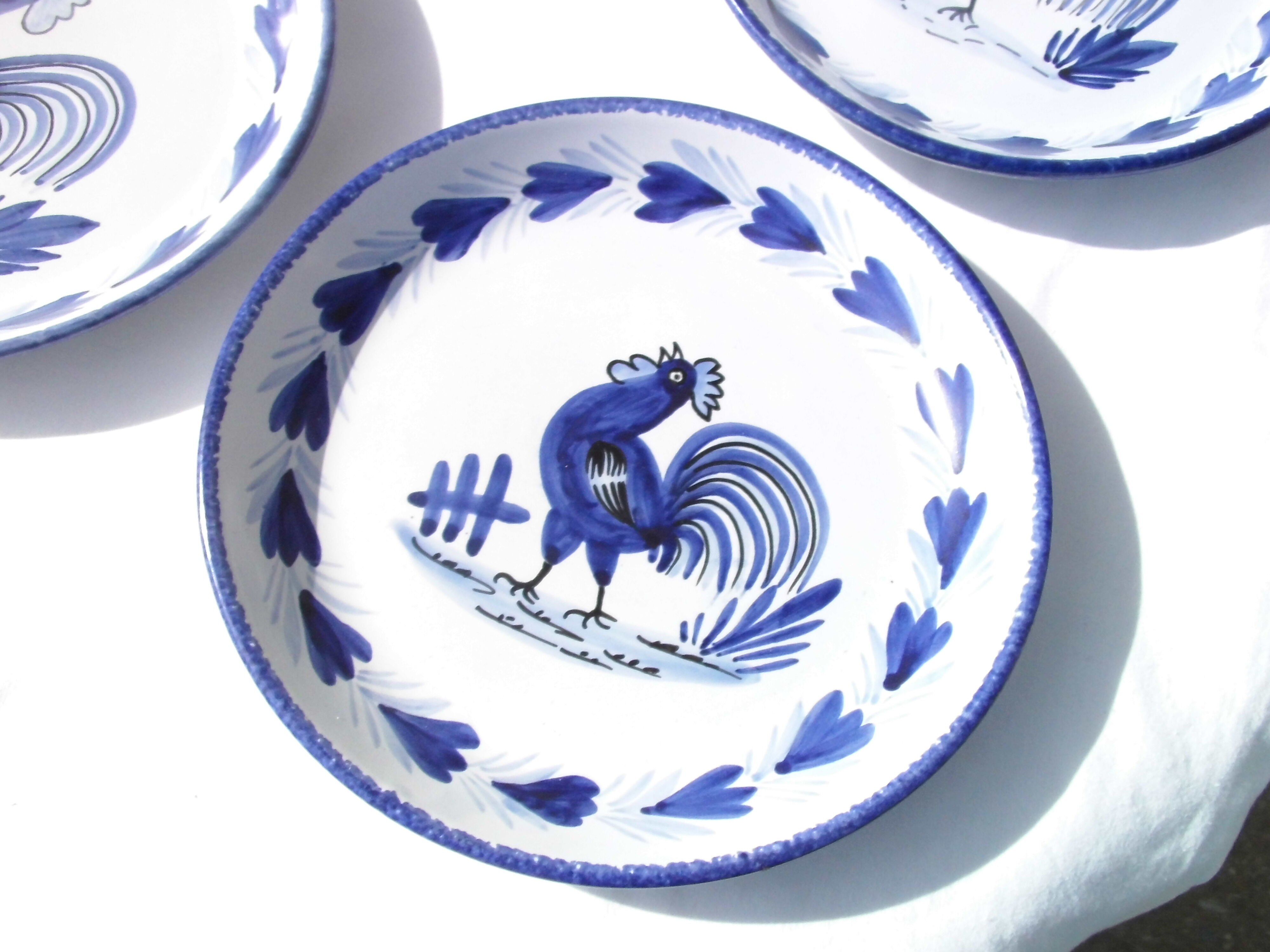 4 Quimper earthenware hollow plates decorated with blue rooster