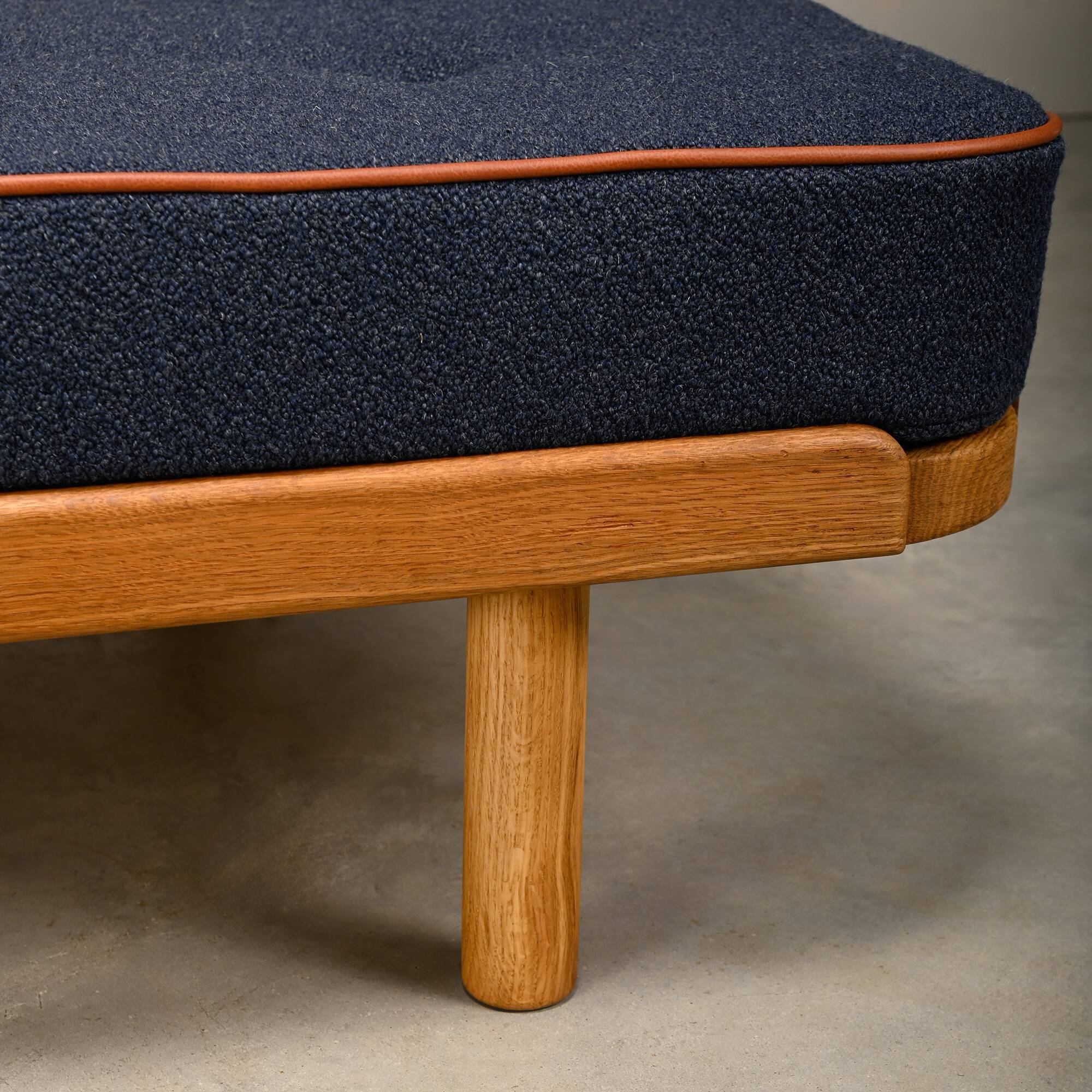 Scandinavian Daybed in Oak and dark Blue bouclé fabric with Leather accents