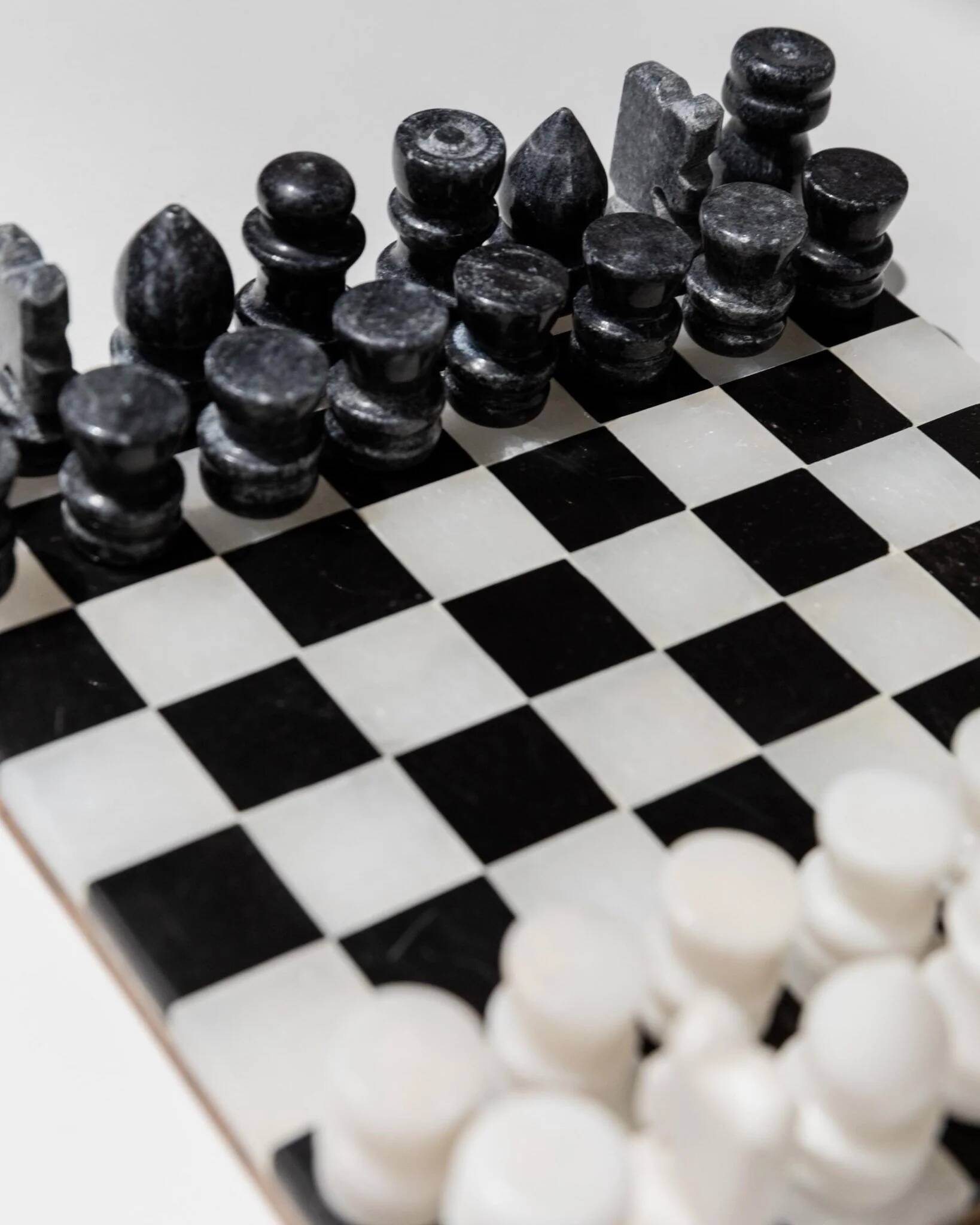 Vintage black-and-white marble chessboard with matching marble pieces, Italian 1960s design, sculptural centerpiece