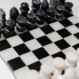 Vintage black-and-white marble chessboard with matching marble pieces, Italian 1960s design, sculptural centerpiece