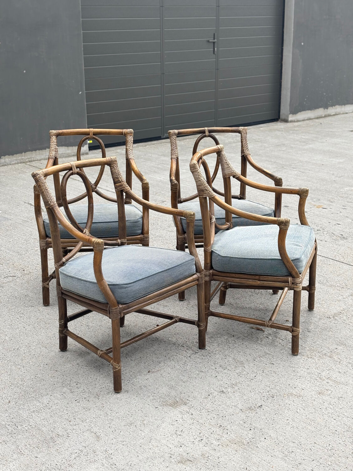 Set of 4 vintage McGuire rattan chairs with cushions.