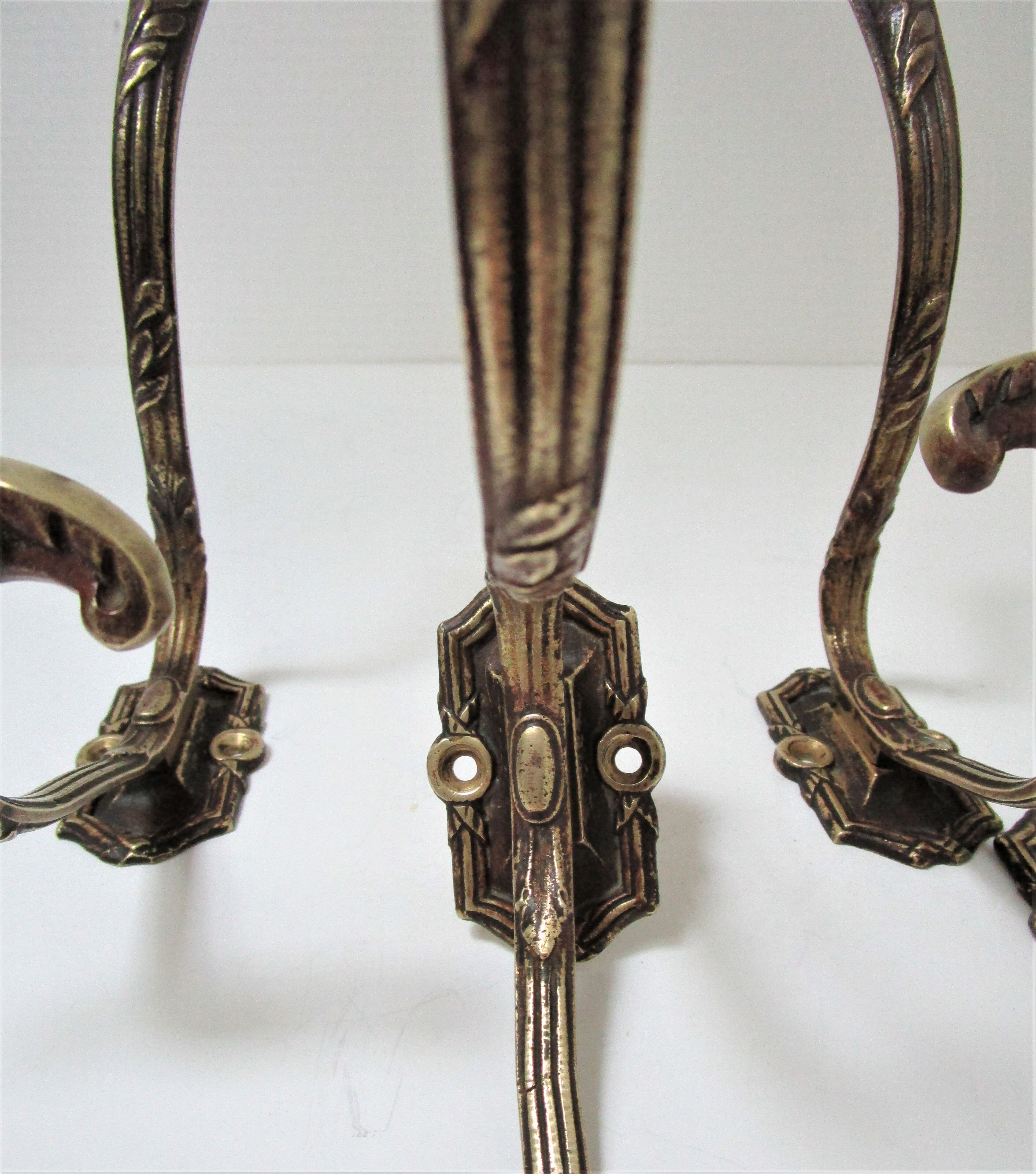 Four patères bronze patinated leafy décor early 20th century
