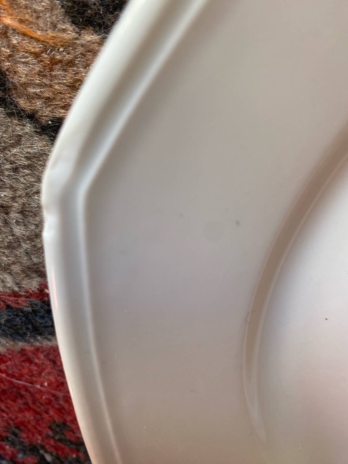 5 mismatched old white plates.