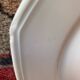 5 mismatched old white plates.