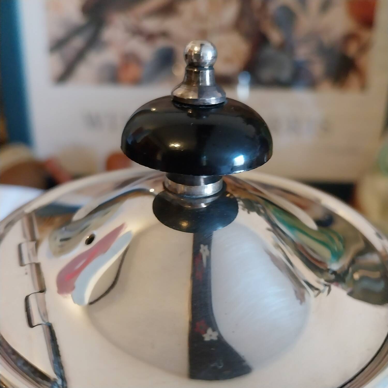 Old English teapot in silver-plated metal and Bakelite.