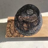Braided rattan suspension in the shape of a black accordion