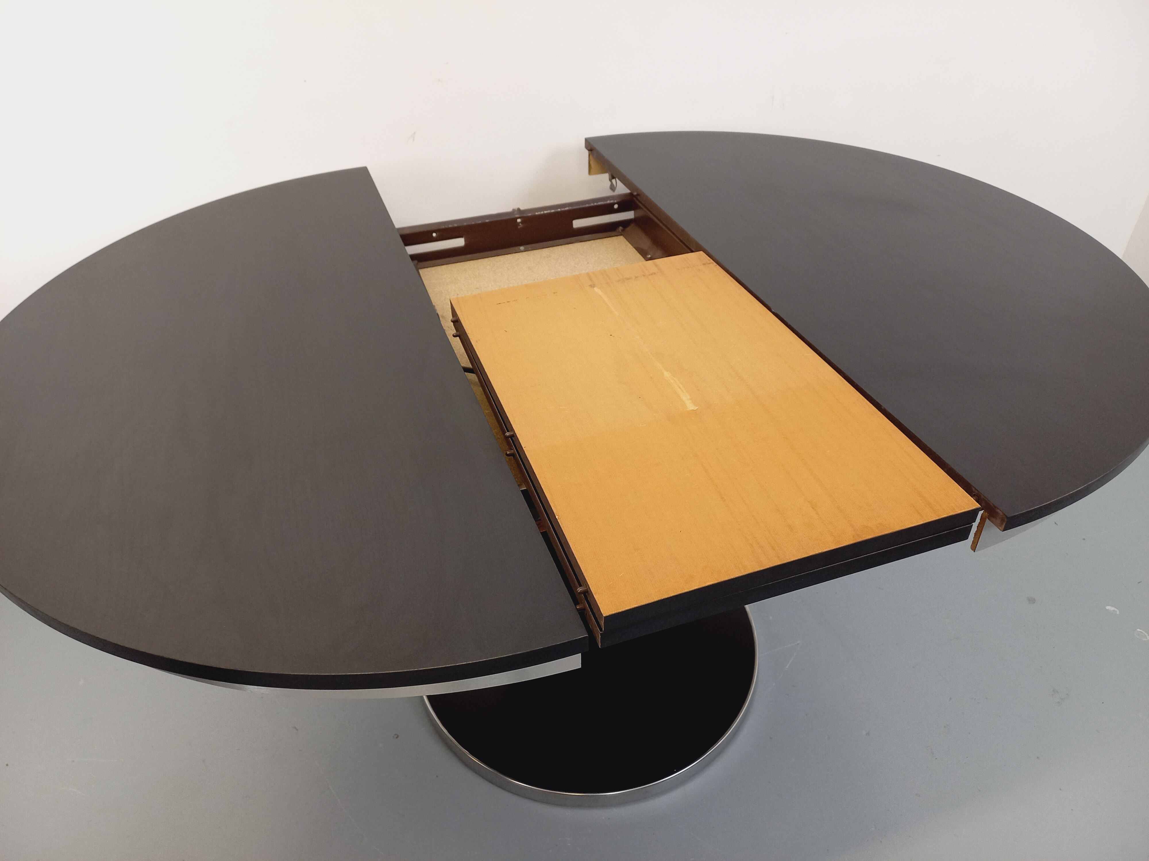 Vintage dining table in melamine with a black wood effect and chrome metal.
