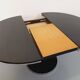 Vintage dining table in melamine with a black wood effect and chrome metal.