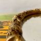 Small vintage oval wall mirror in varnished gold resin