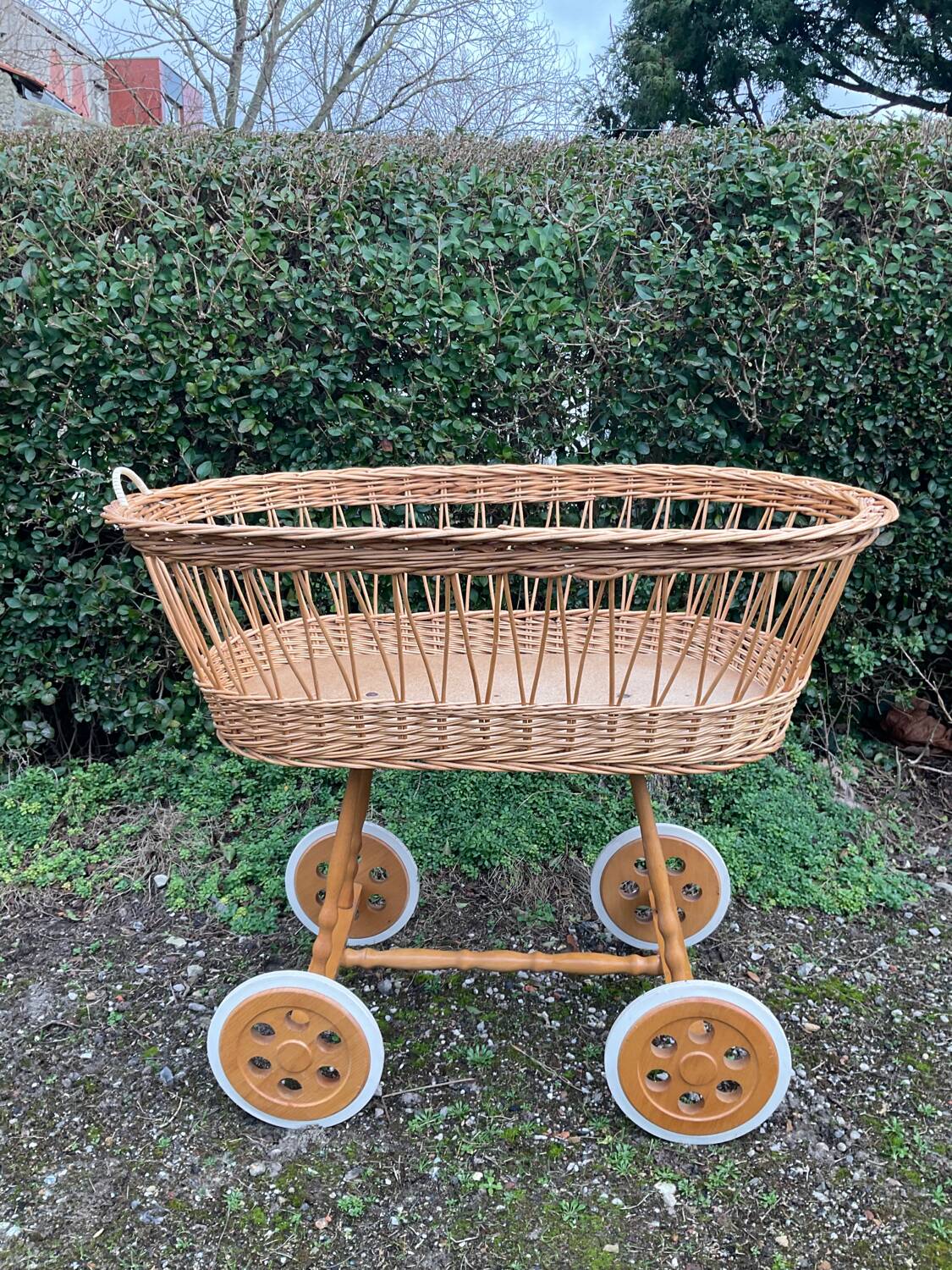 Vintage wicker cradle on casters