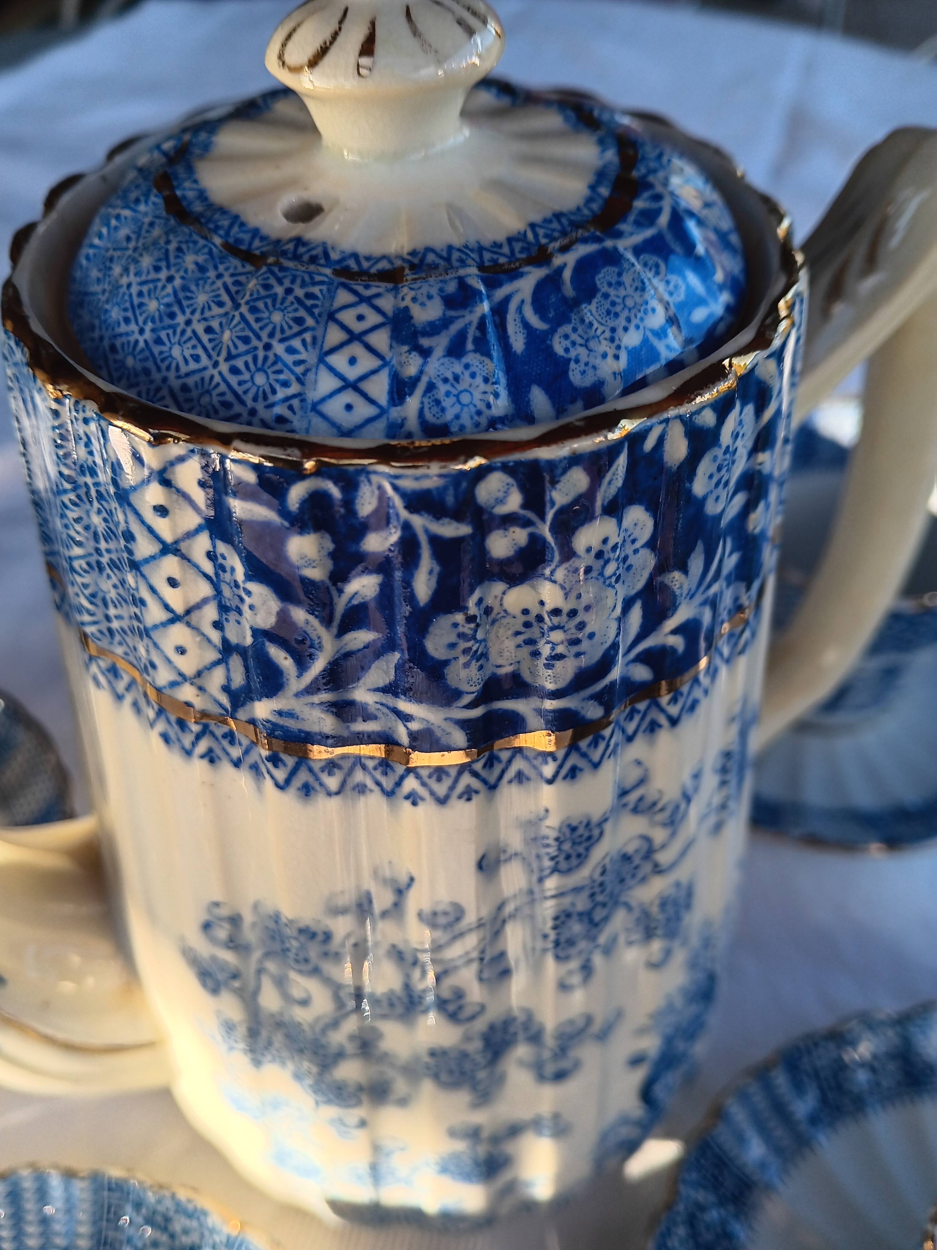 Old coffee service Lunéville with blue lace decoration.