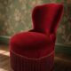 Vintage burgundy velvet armchair with fringes – theatrical and elegant