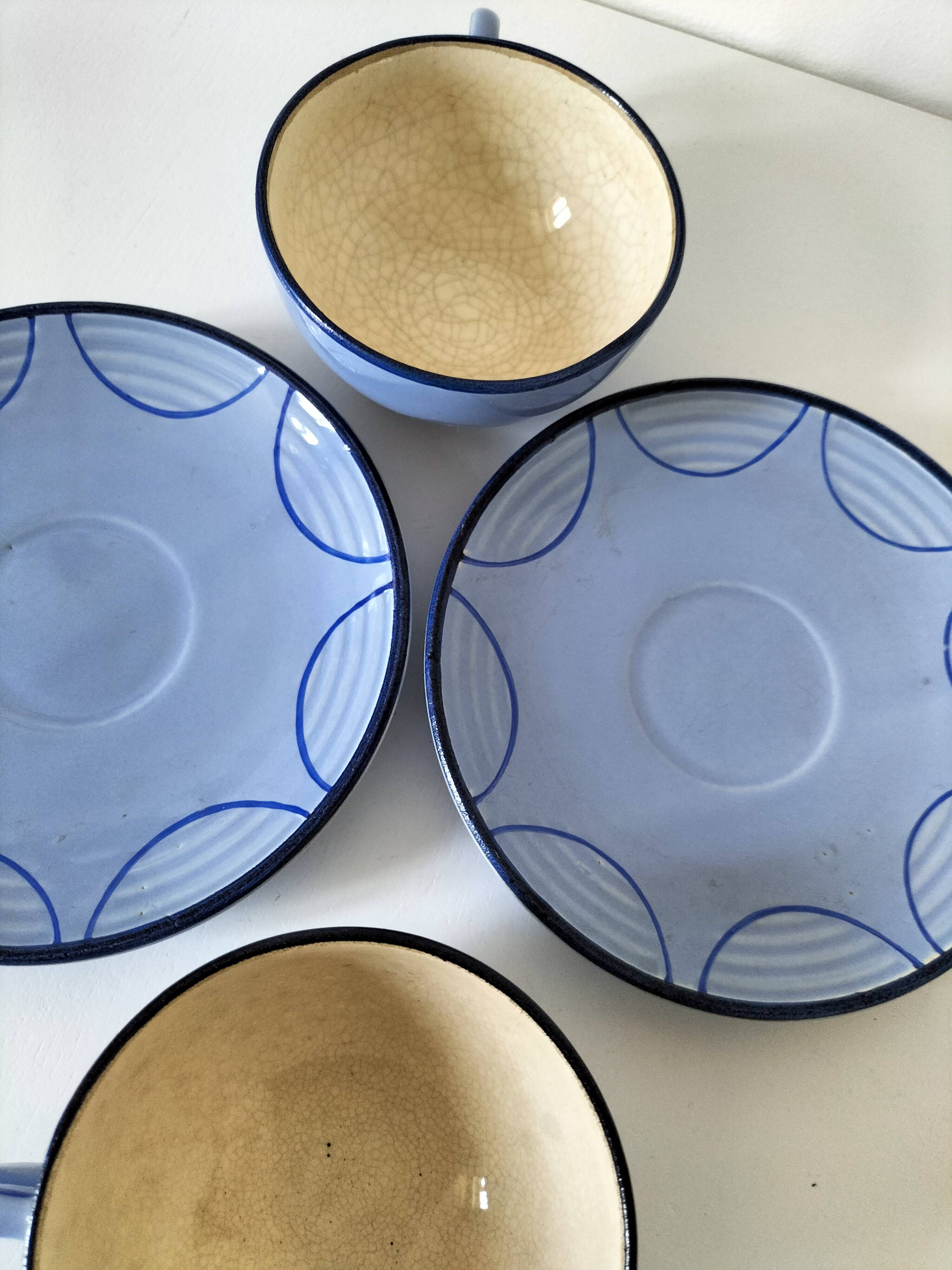 A pair of glazed ceramic cups and saucers from the 60s-70s.