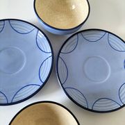 A pair of glazed ceramic cups and saucers from the 60s-70s.