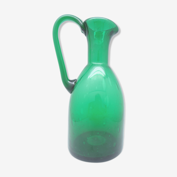 Green pitcher vase made of blown glass