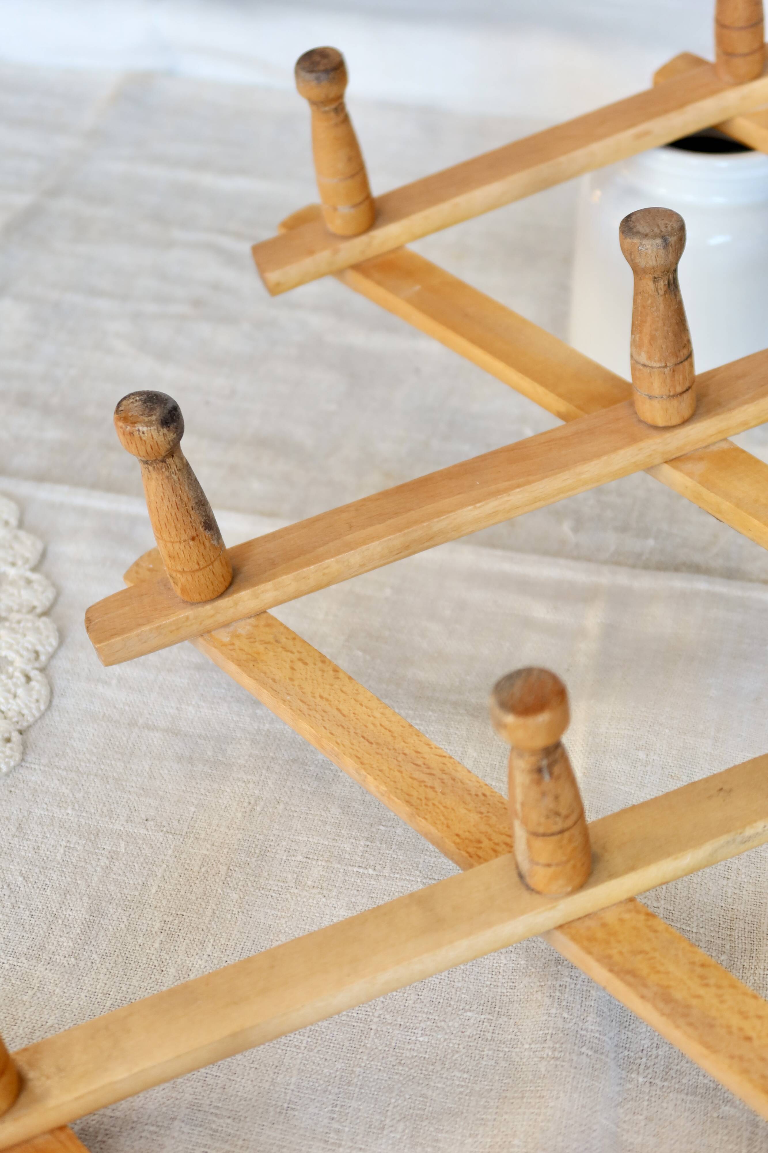 Vintage retractable wall-mounted coat rack made of pine wood