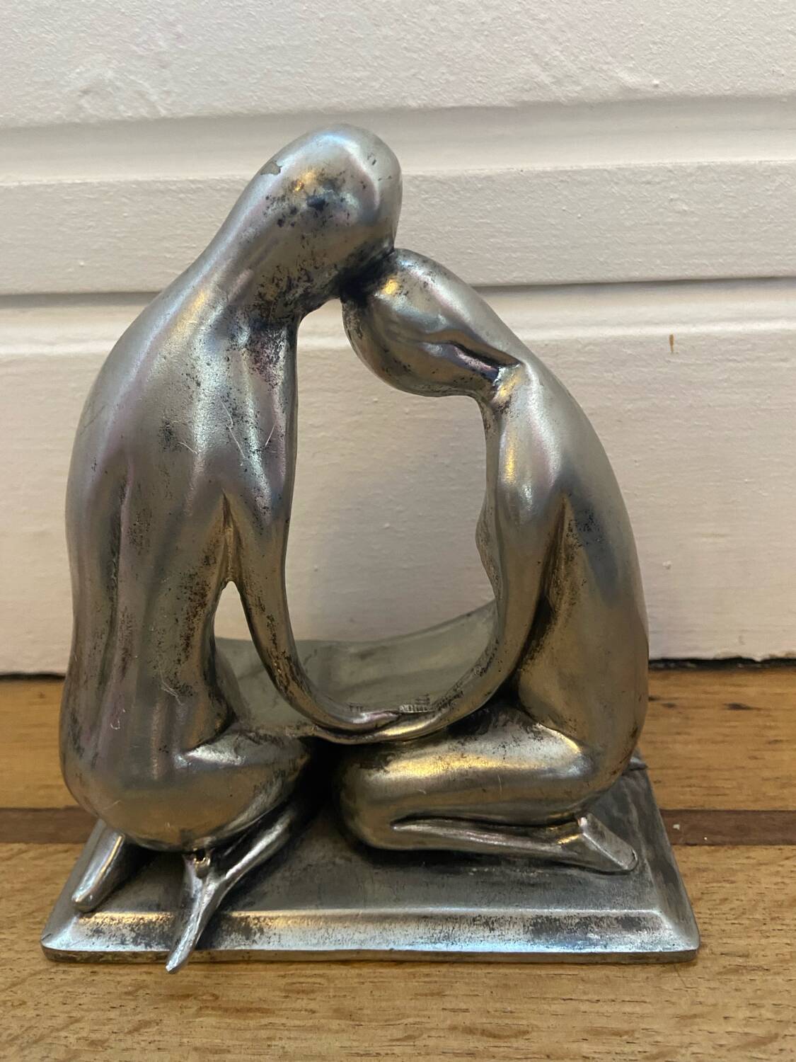 Tin figurine of a couple in love