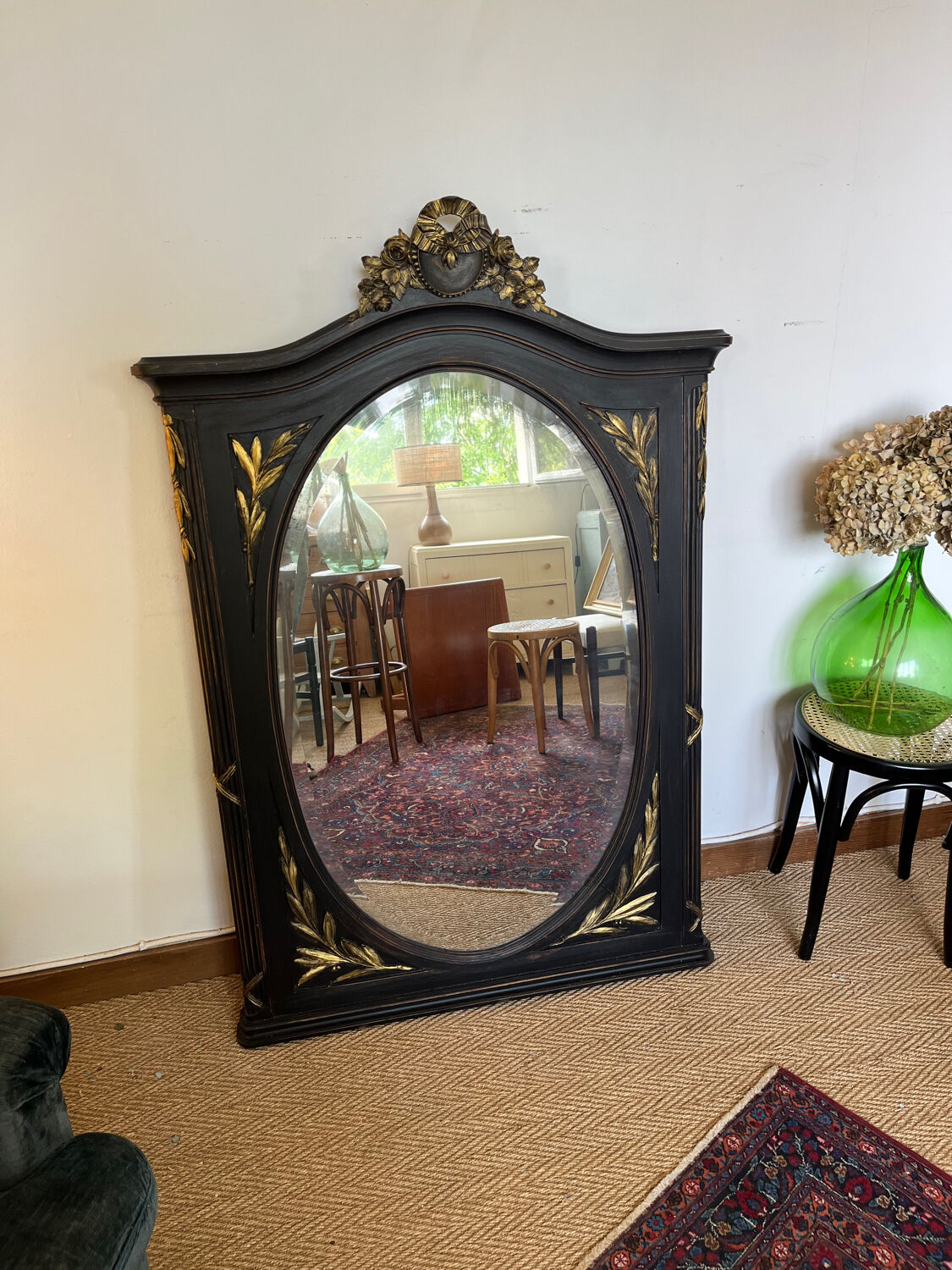 Large old trumeau mirror in black and gilded wood Napoleon style