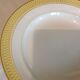Six white hollow plates on board yellow Monaco 60