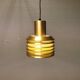 Hanging lamp in gold-colored aluminum with many layers of shades.