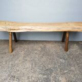 Big bench in solid rough wood very thick Brutalism