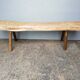 Big bench in solid rough wood very thick Brutalism
