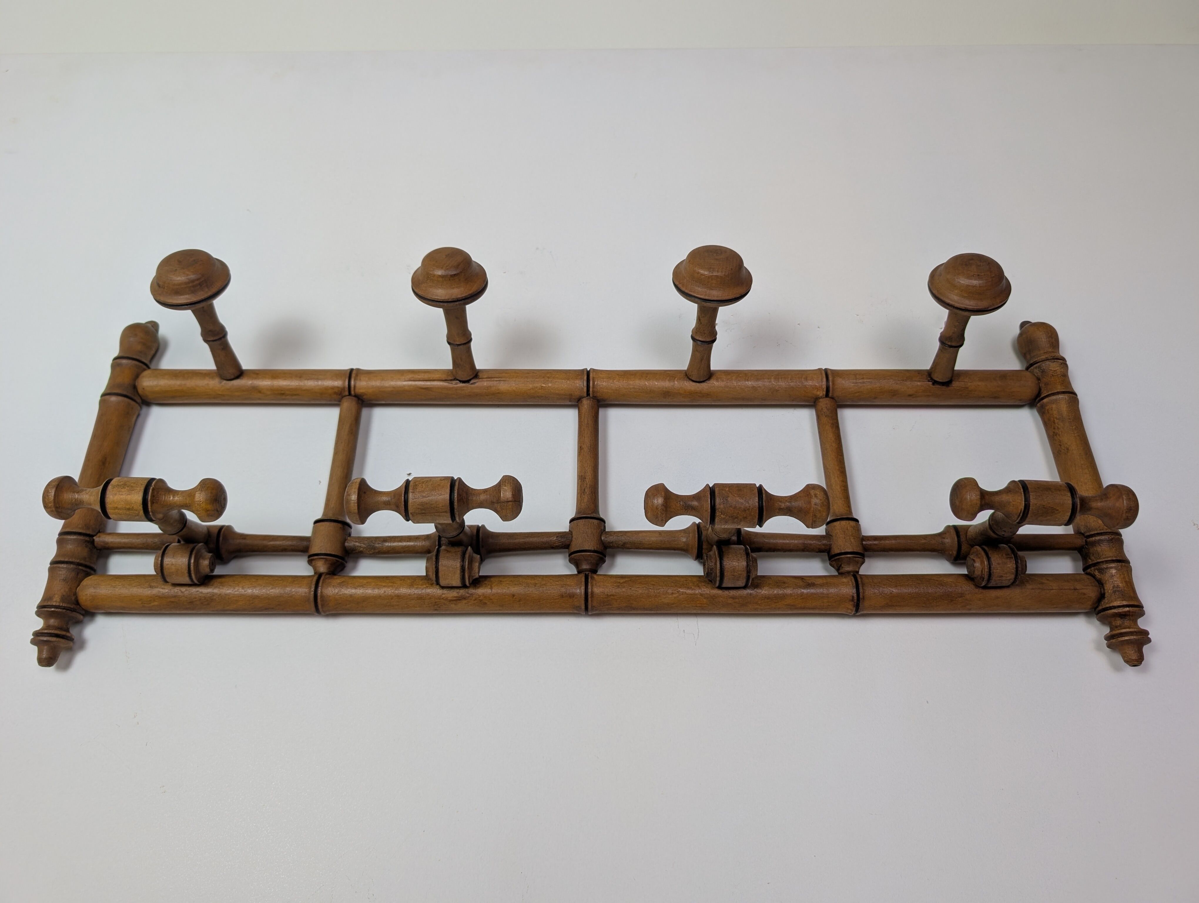 Wall-mounted coat rack made of turned wood
