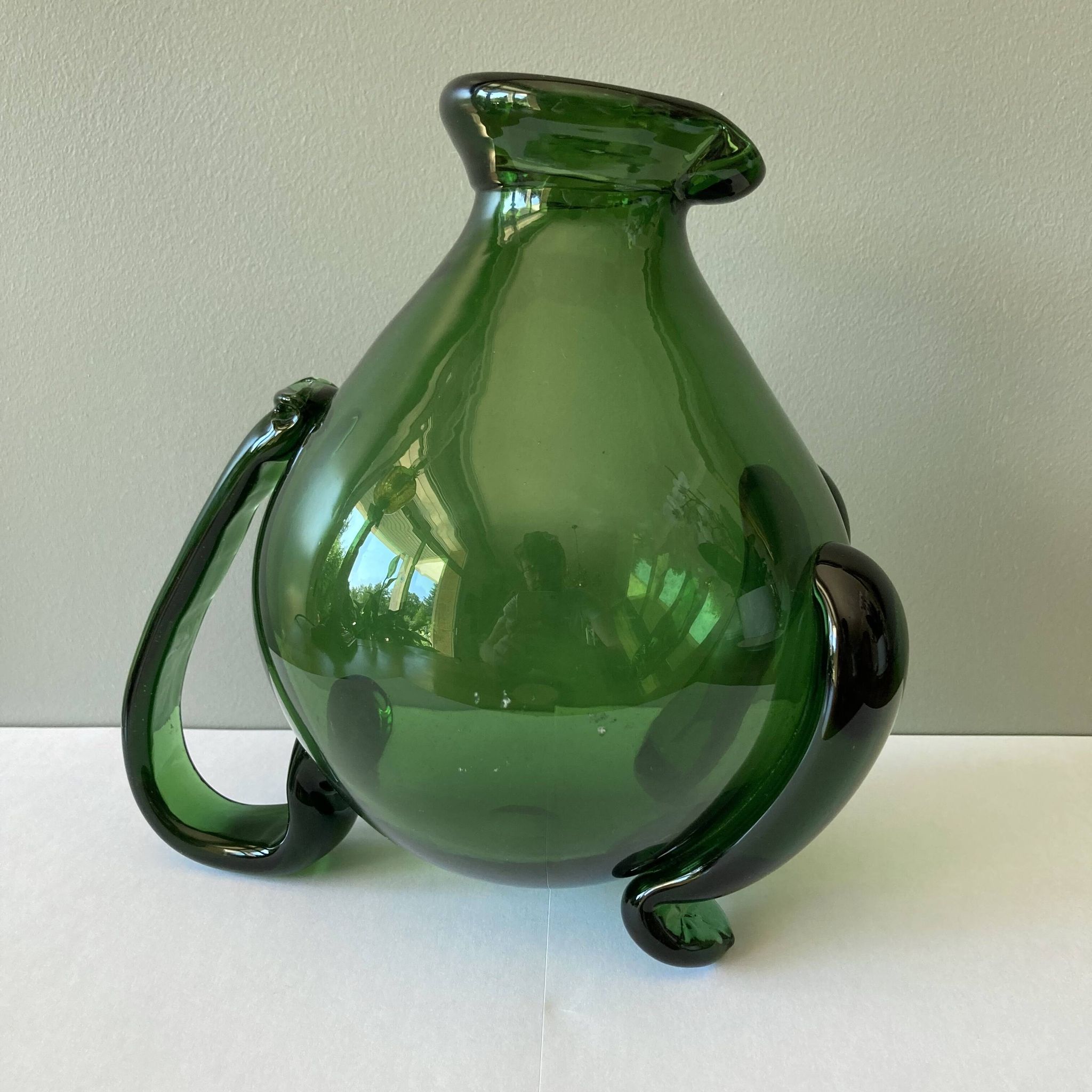 Amazing pitcher; vintage tripod jug or carafe in blown and hot-worked green glass